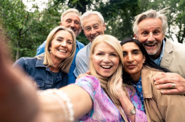 A group of mature happy people socialising together