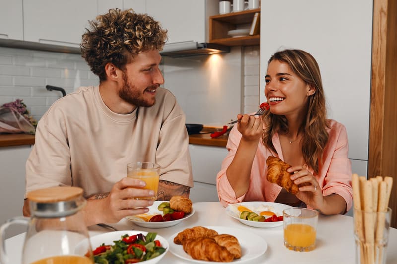 A young couple enjoying a healthy meal together at home
