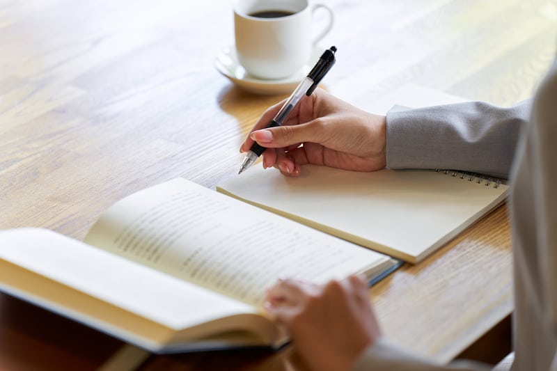 Woman sitting at desk, studying for qualifications